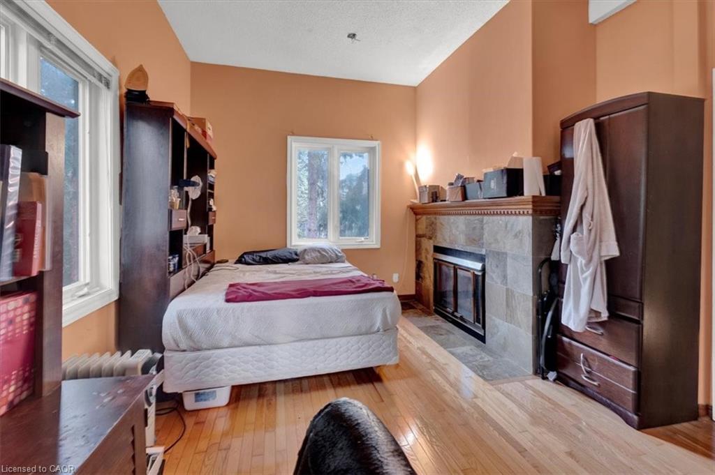 1-1983 Main Street W, Hamilton, ON - Indoor Photo Showing Bedroom With Fireplace