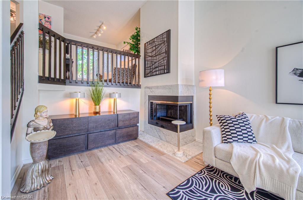 56-225 Benjamin Road, Waterloo, ON - Indoor Photo Showing Living Room With Fireplace