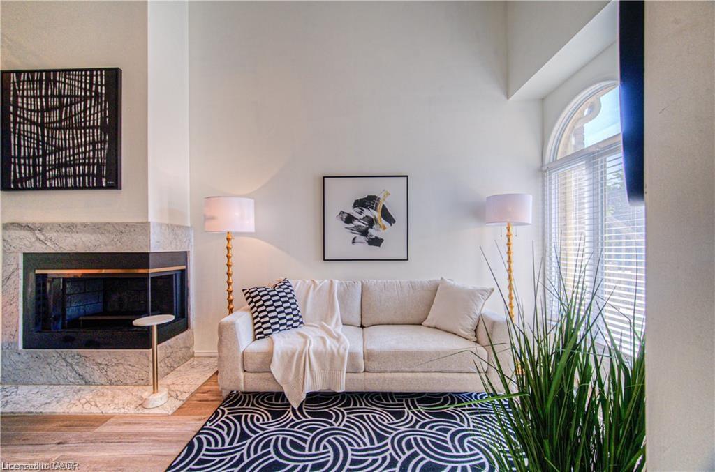 56-225 Benjamin Road, Waterloo, ON - Indoor Photo Showing Living Room With Fireplace