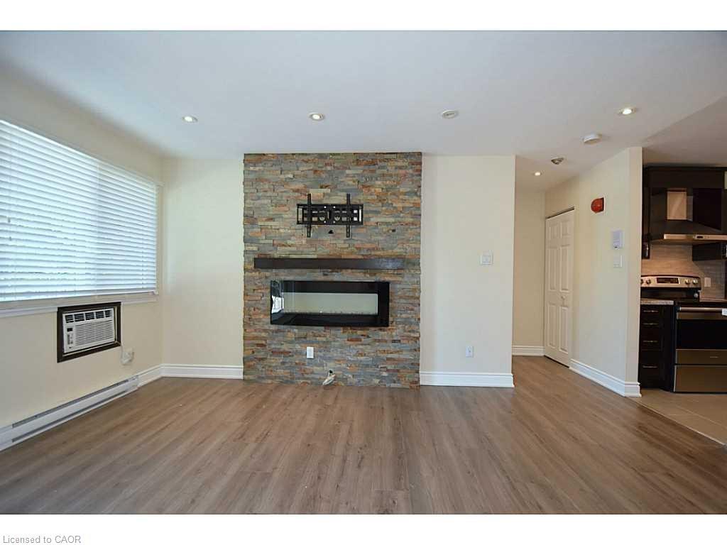 821-1450 Glen Abbey Gate, Oakville, ON - Indoor Photo Showing Living Room With Fireplace