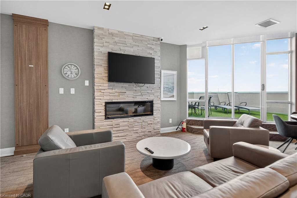 811-1276 Maple Crossing Boulevard, Burlington, ON - Indoor Photo Showing Living Room With Fireplace