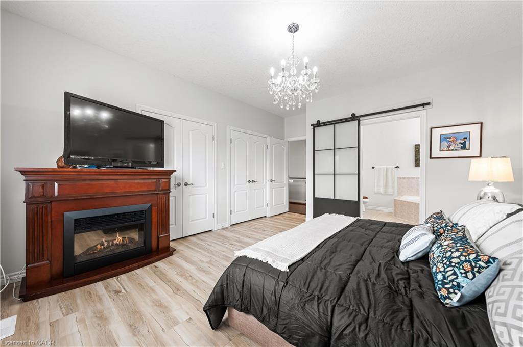 18-152 Devonshire Drive, New Hamburg, ON - Indoor Photo Showing Bedroom With Fireplace