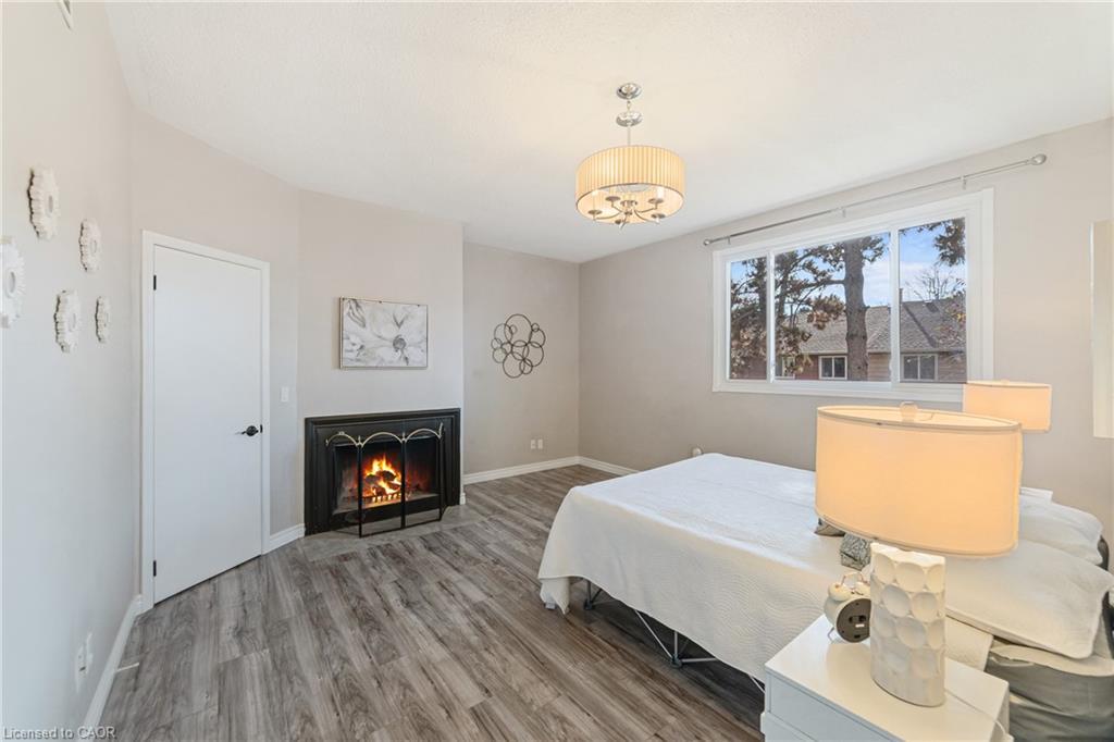 6-4199 Longmoor Drive, Burlington, ON - Indoor Photo Showing Bedroom With Fireplace