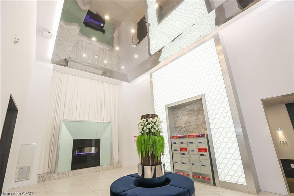 530-16 Concord Place, Grimsby, ON - Indoor Photo Showing Other Room With Fireplace