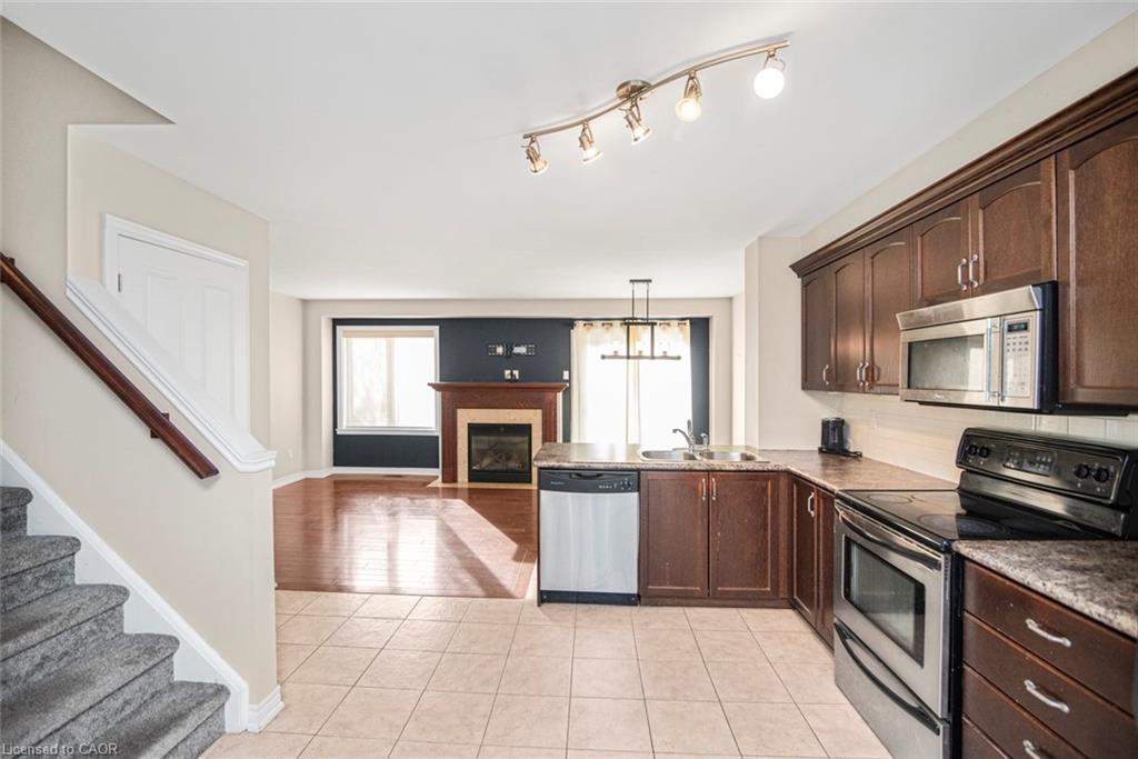 23-222 Fall Fair Way, Binbrook, ON - Indoor Photo Showing Kitchen With Fireplace With Double Sink