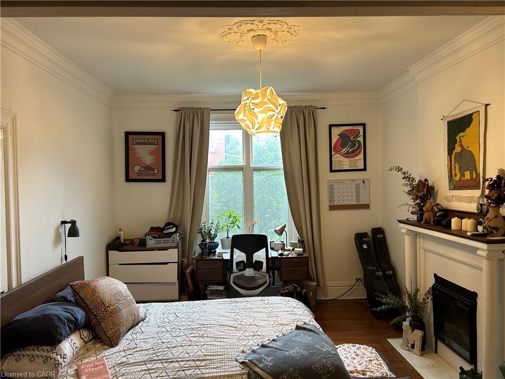 Main-207 Charlton Avenue W, Hamilton, ON - Indoor Photo Showing Bedroom With Fireplace