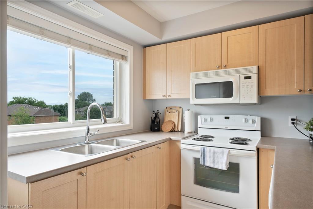 304-4450 Fairview Street, Burlington, ON - Indoor Photo Showing Kitchen With Double Sink