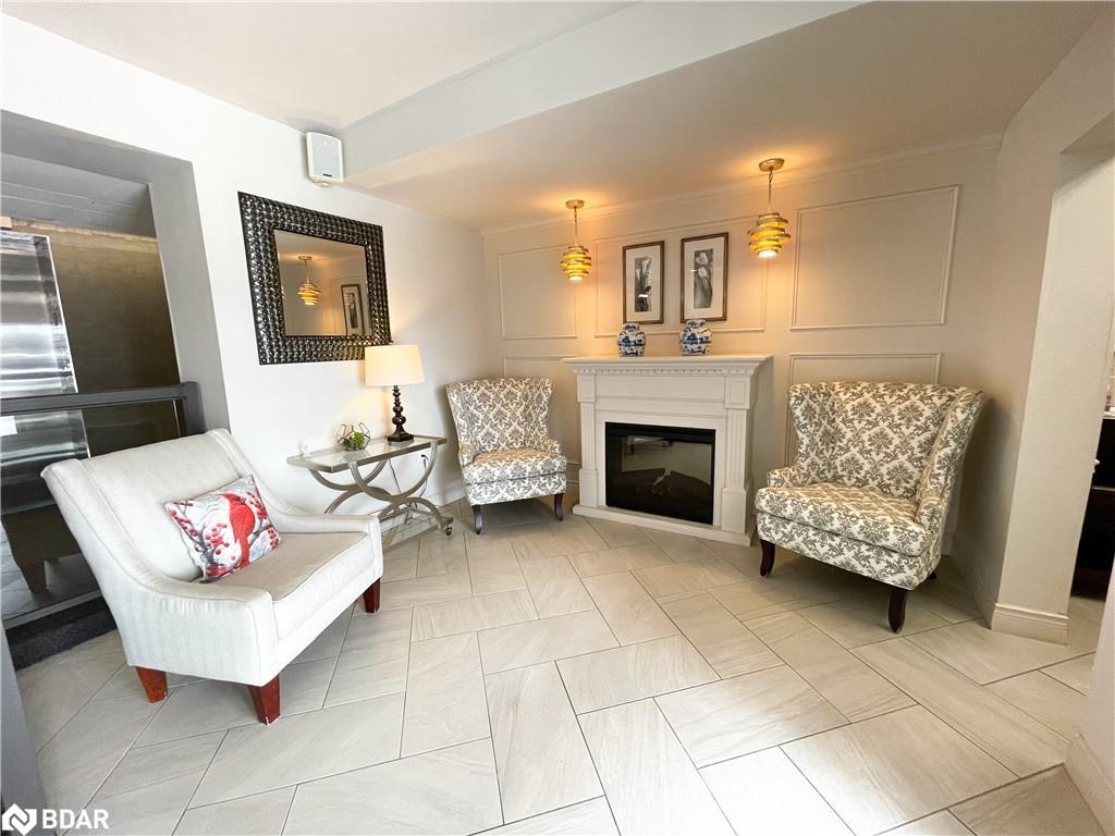 702-414 Blake Street, Barrie, ON - Indoor Photo Showing Living Room With Fireplace