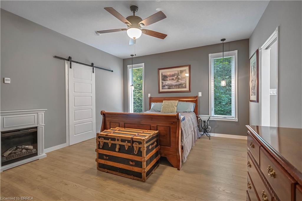 156 St Johns Road W, Simcoe, ON - Indoor Photo Showing Bedroom With Fireplace