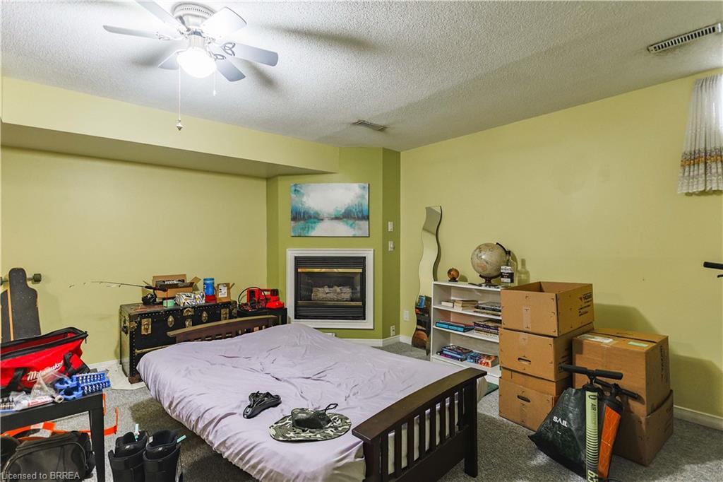 31-1115 Nellis Street, Woodstock, ON - Indoor Photo Showing Bedroom With Fireplace