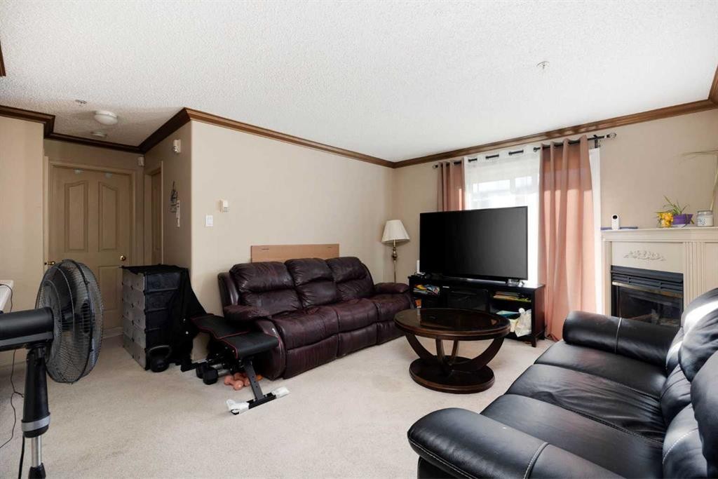 111-100 Richard Street, Fort Mcmurray, AB - Indoor Photo Showing Living Room With Fireplace