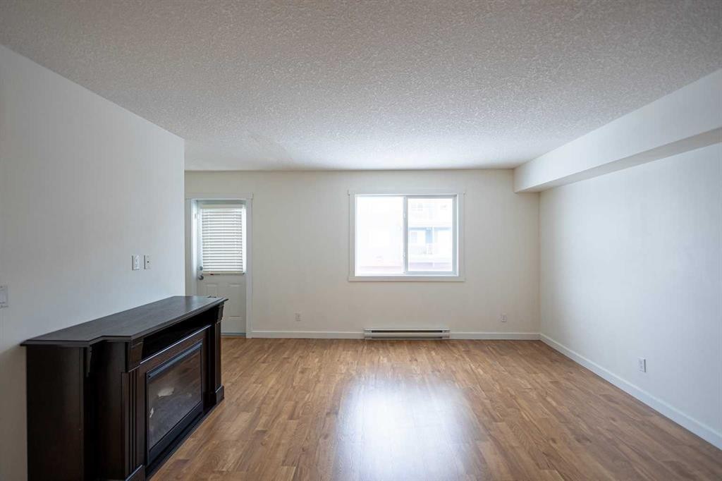 208-234 Stony Mountain Road, Anzac, AB - Indoor Photo Showing Other Room With Fireplace