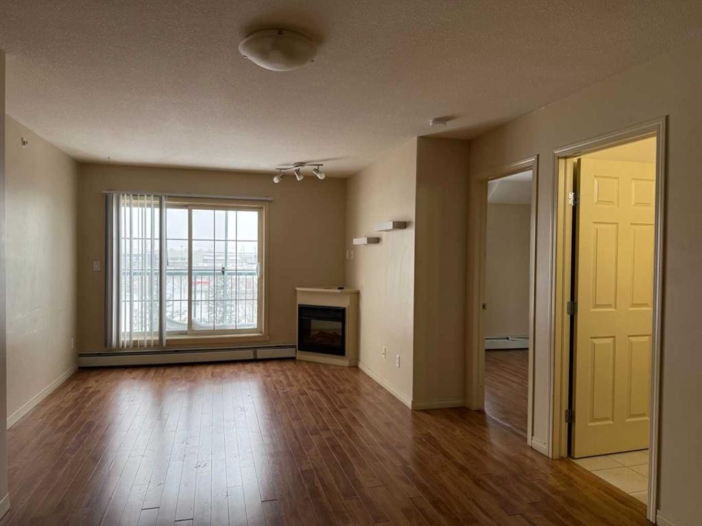 1410-200 Lougheed Drive, Fort Mcmurray, AB - Indoor Photo Showing Living Room With Fireplace