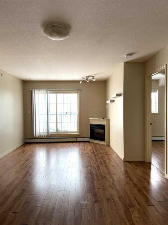 1410-200 Lougheed Drive, Fort Mcmurray, AB - Indoor Photo Showing Living Room With Fireplace