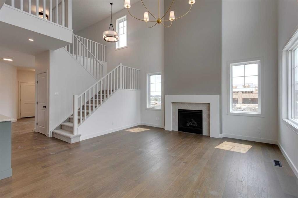 21 Bayview Mews Sw, Airdrie, AB - Indoor Photo Showing Other Room With Fireplace