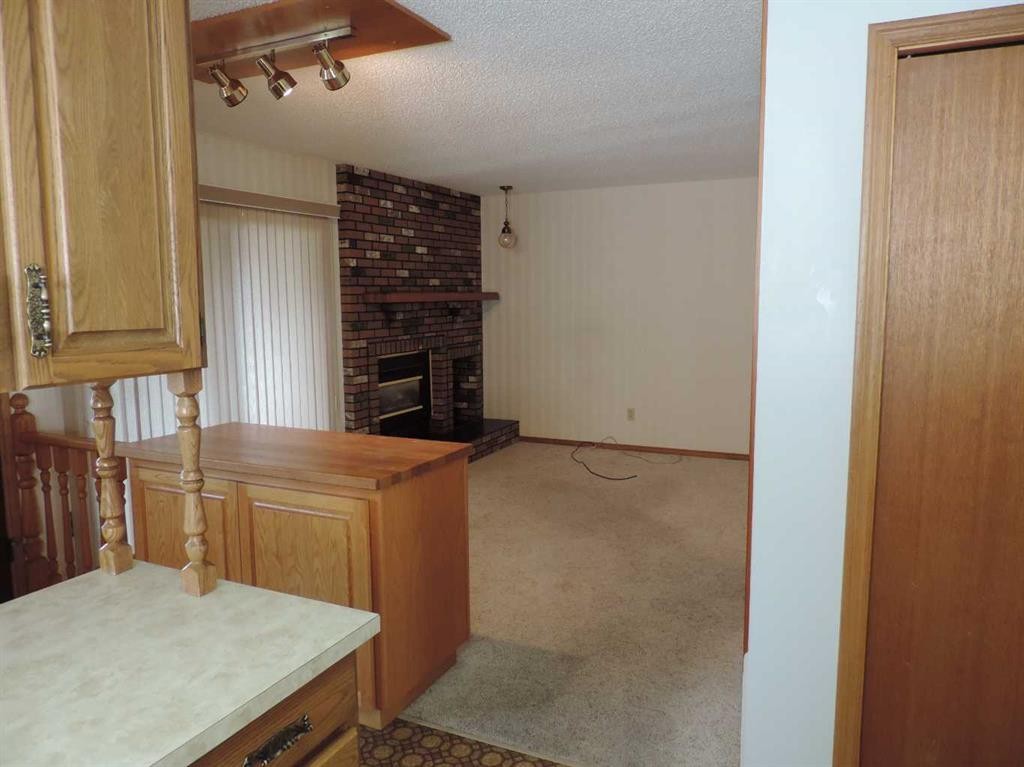 4737 54 Avenue, Rimbey, AB - Indoor Photo Showing Other Room With Fireplace