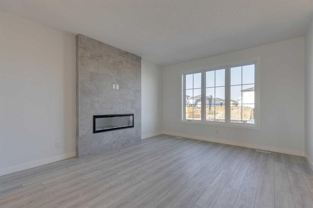 95 Southborough Crescent, Cochrane, AB - Indoor Photo Showing Other Room With Fireplace
