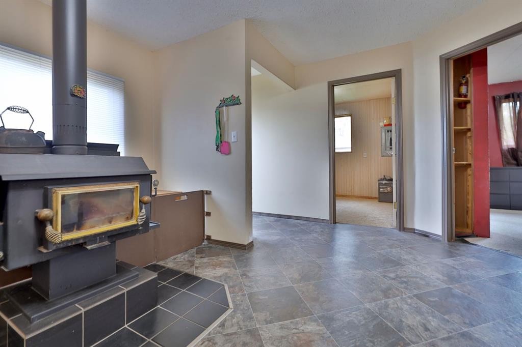 126 Alberta Street, New Norway, AB - Indoor Photo Showing Other Room With Fireplace