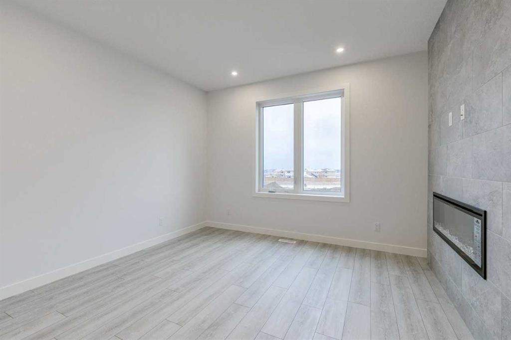 205 Bridgeport Gate, Chestermere, AB - Indoor Photo Showing Other Room With Fireplace