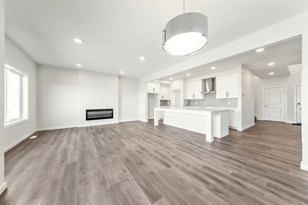 8 Heritage Link, Cochrane, AB - Indoor With Fireplace
