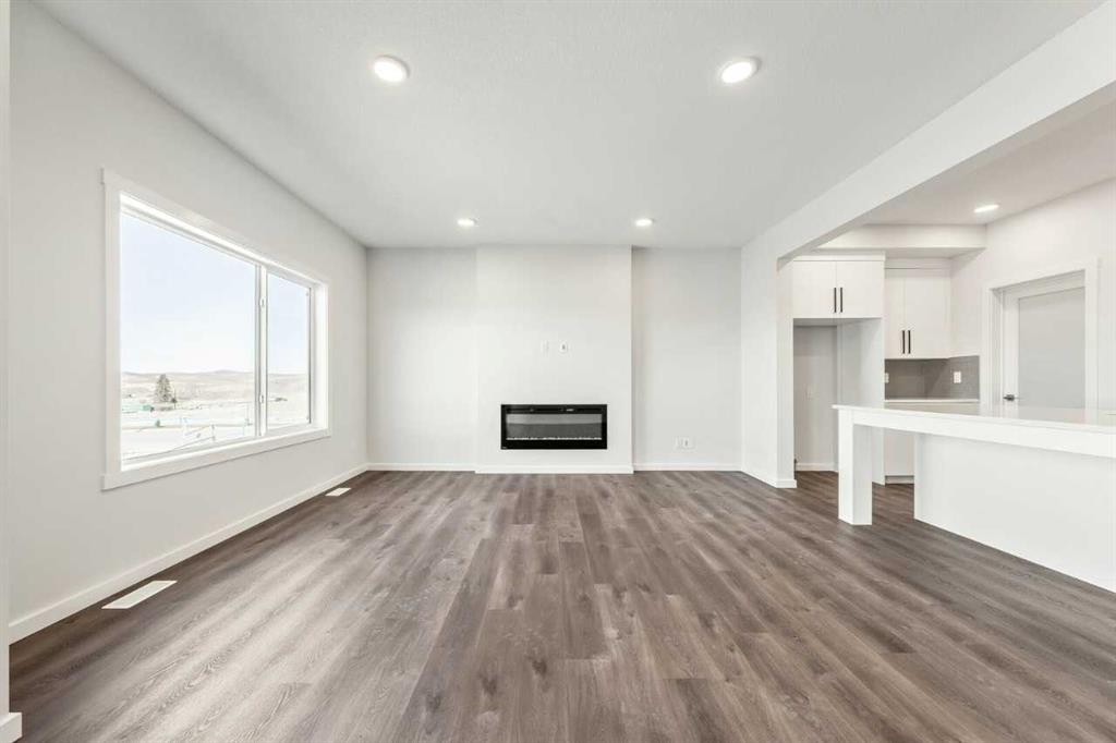 8 Heritage Link, Cochrane, AB - Indoor With Fireplace