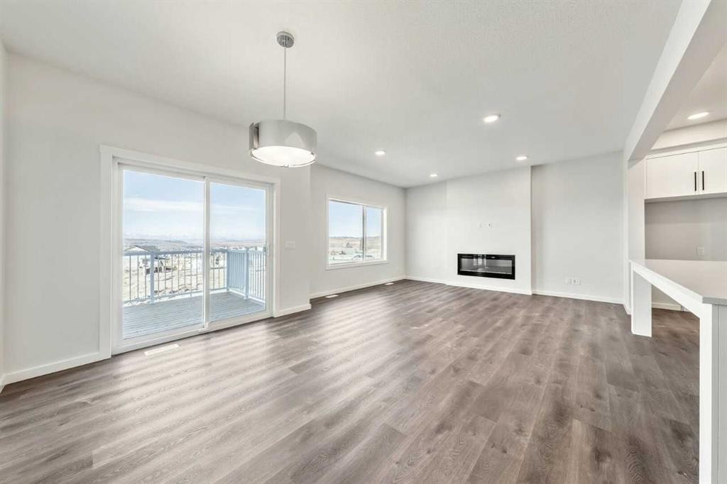 8 Heritage Link, Cochrane, AB - Indoor Photo Showing Other Room With Fireplace