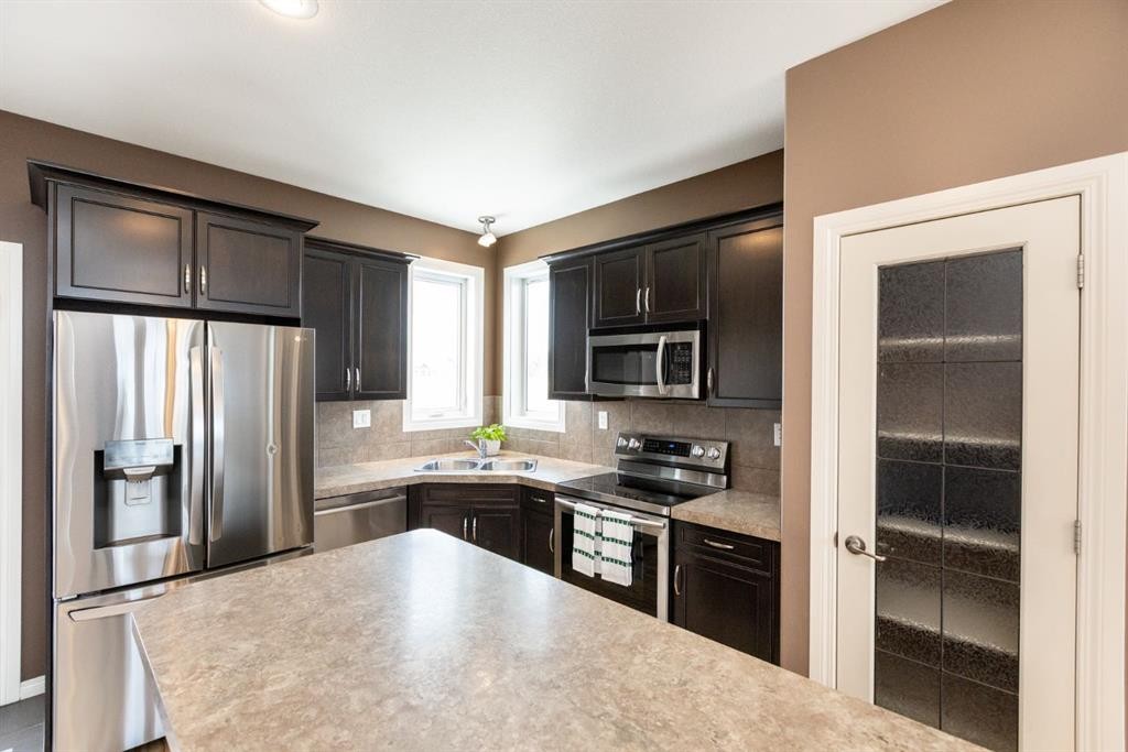 6321 58 Avenue, Innisfail, AB - Indoor Photo Showing Kitchen With Stainless Steel Kitchen With Double Sink