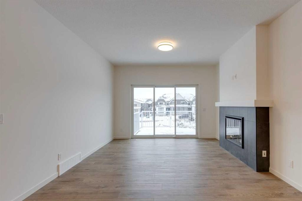 1402 Bayview Crescent Sw, Airdrie, AB - Indoor With Fireplace