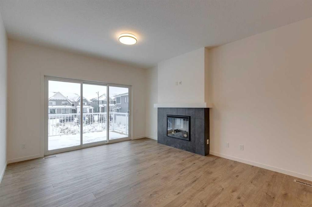 1402 Bayview Crescent Sw, Airdrie, AB - Indoor Photo Showing Living Room With Fireplace