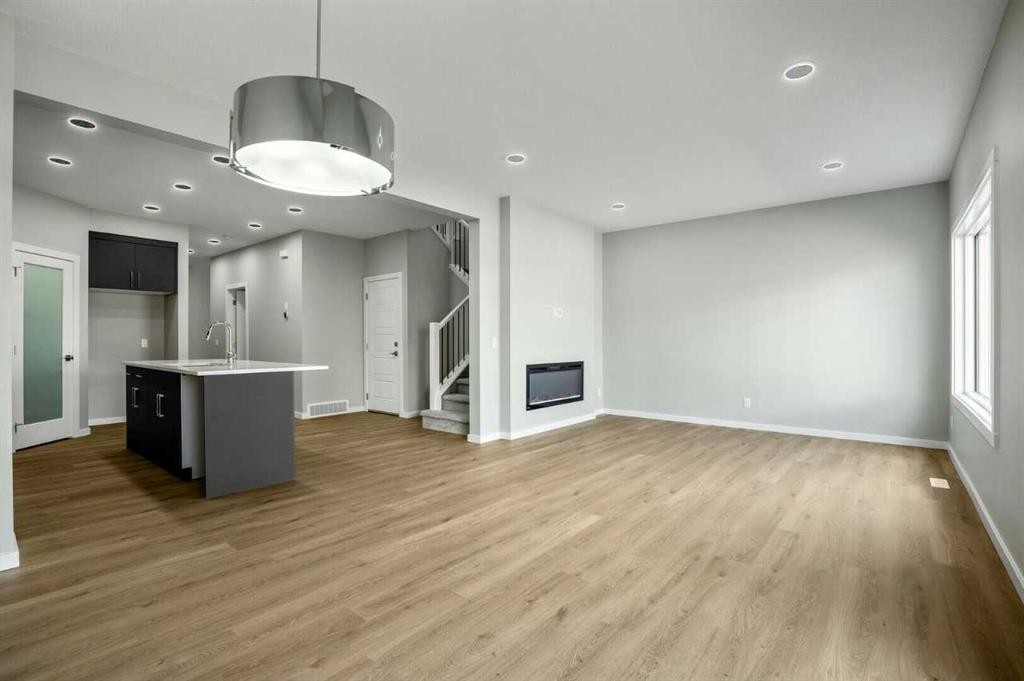 11 Heritage Link, Cochrane, AB - Indoor With Fireplace