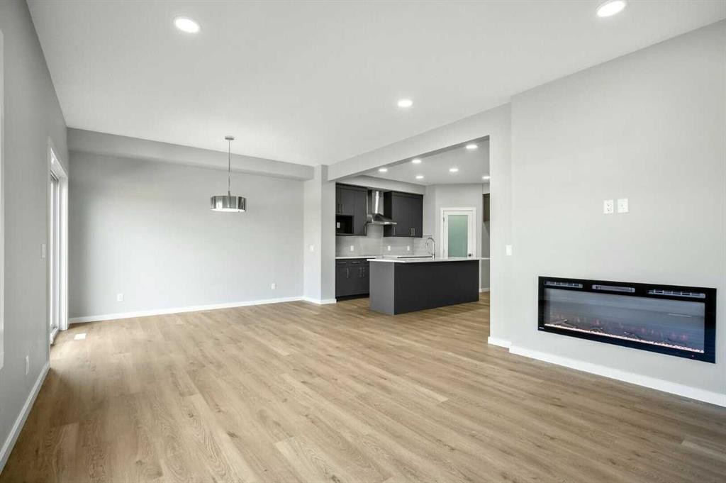 11 Heritage Link, Cochrane, AB - Indoor With Fireplace