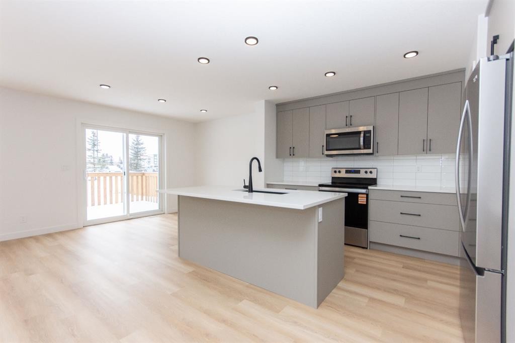 12 Trinity Street, Lacombe, AB - Indoor Photo Showing Kitchen With Stainless Steel Kitchen With Upgraded Kitchen