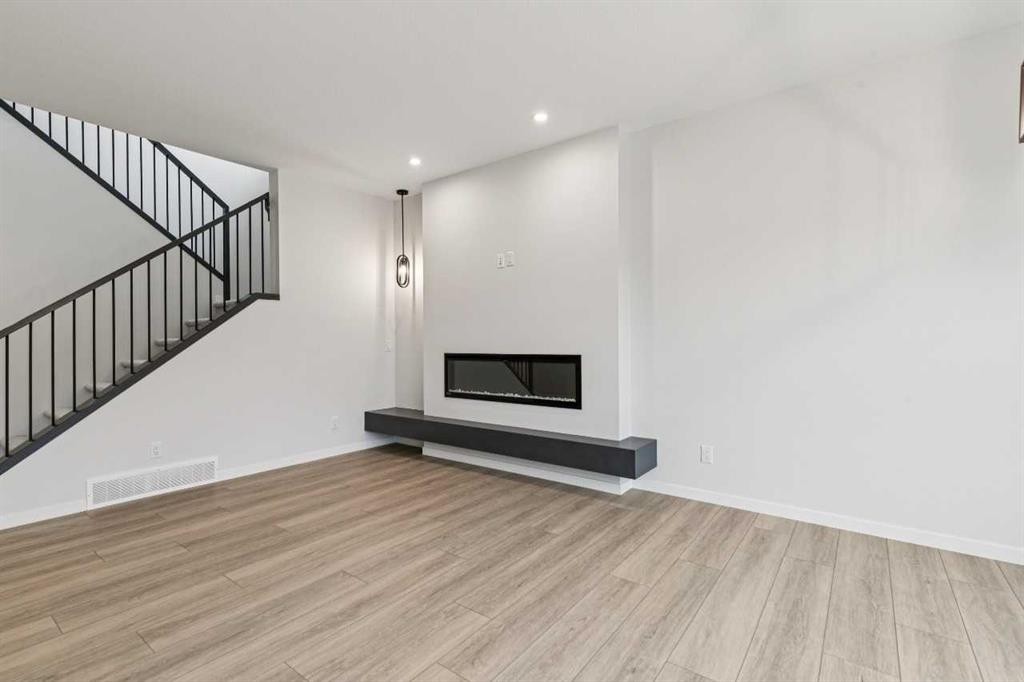 572 Belmont Heath Sw, Calgary, AB - Indoor With Fireplace