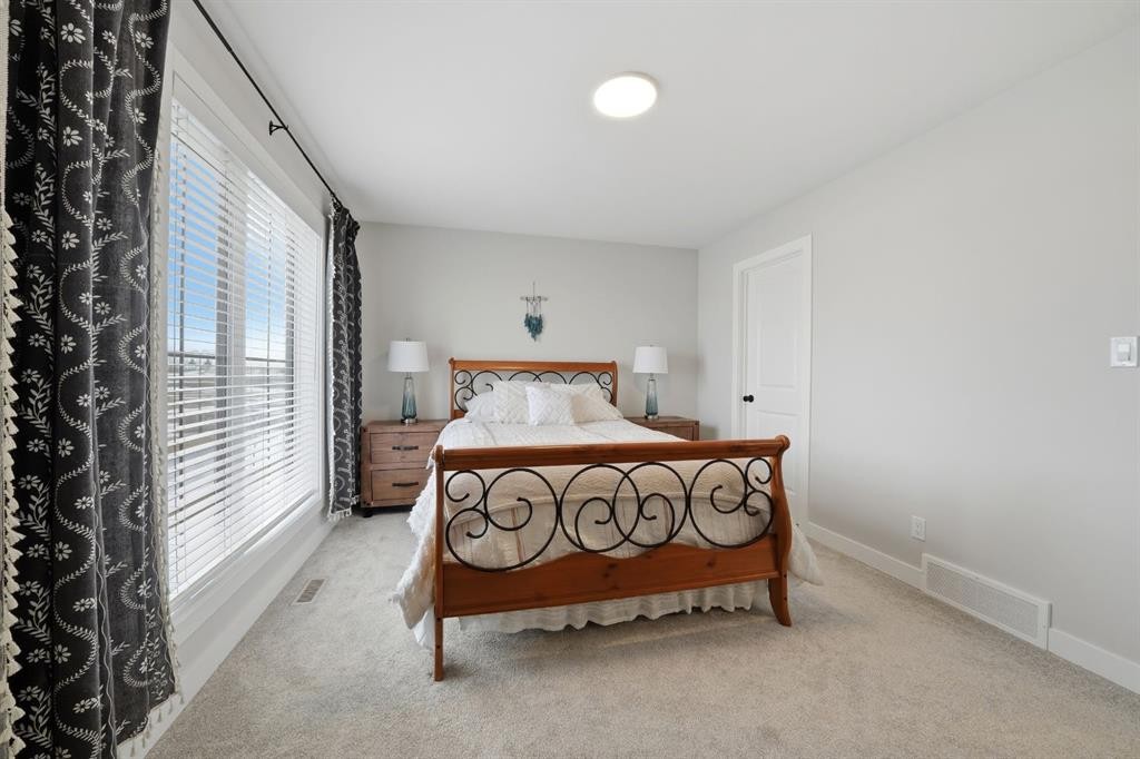 32 Station Drive, Sylvan Lake, AB - Indoor Photo Showing Bedroom