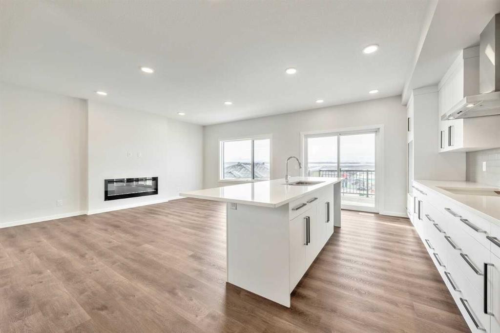 24 Heritage Link, Cochrane, AB - Indoor Photo Showing Kitchen With Fireplace With Upgraded Kitchen