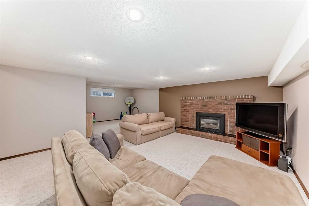 128 Dickenson Crescent, Red Deer, AB - Indoor Photo Showing Other Room With Fireplace