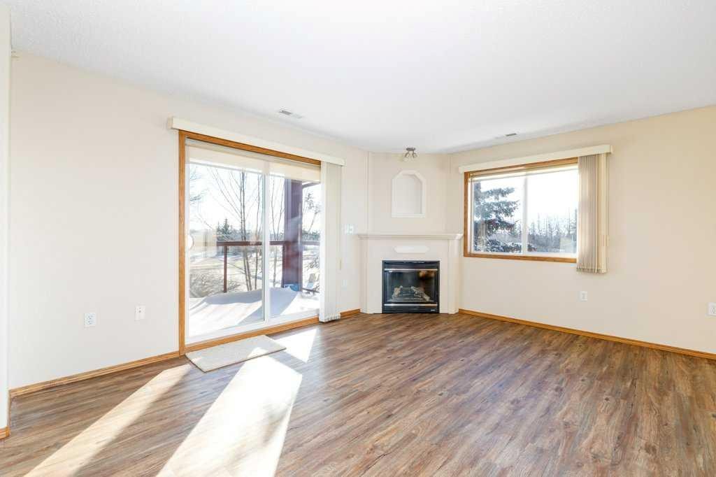 328-18 Averill Street, Red Deer, AB - Indoor Photo Showing Living Room With Fireplace