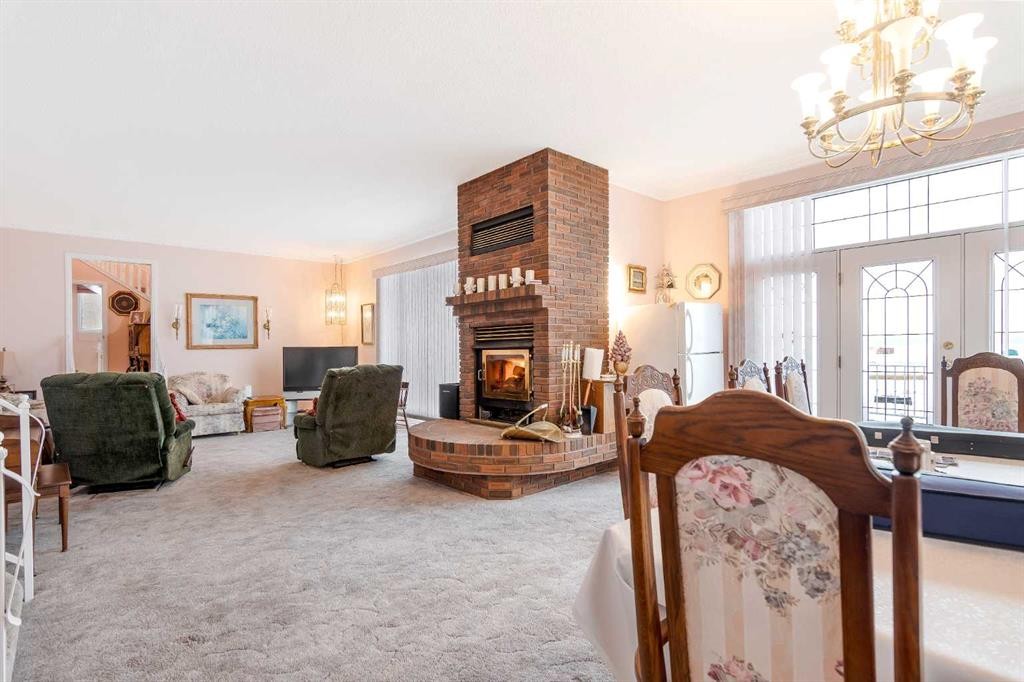 3 Rustic Road, Norglenwold, AB - Indoor With Fireplace