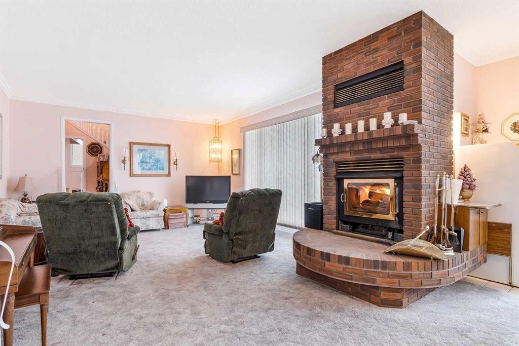3 Rustic Road, Norglenwold, AB - Indoor Photo Showing Living Room With Fireplace