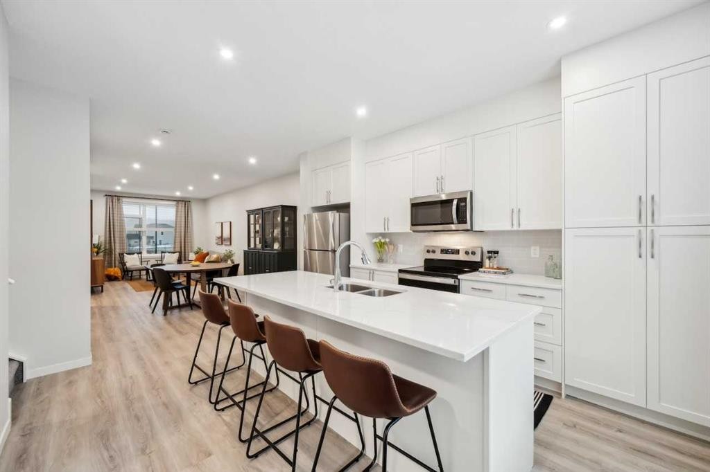 231 Vantage Drive, Cochrane, AB - Indoor Photo Showing Kitchen With Stainless Steel Kitchen With Double Sink With Upgraded Kitchen