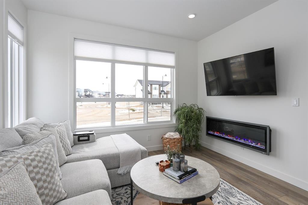 E-2 Evergreen Way, Red Deer, AB - Indoor Photo Showing Living Room With Fireplace