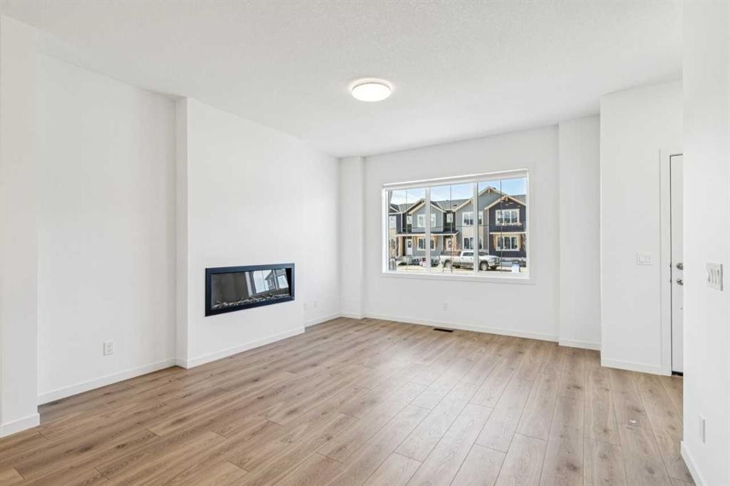 15 Emberside Park, Cochrane, AB - Indoor Photo Showing Living Room With Fireplace