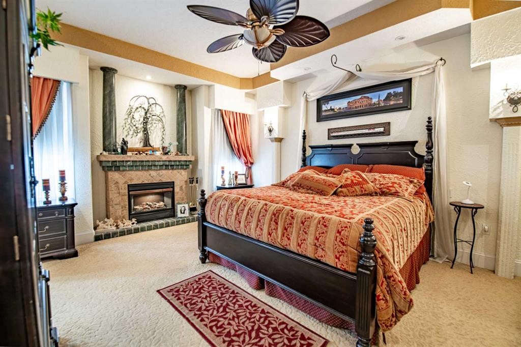 295 Jarvis Glen Close, Jarvis Bay, AB - Indoor Photo Showing Bedroom With Fireplace
