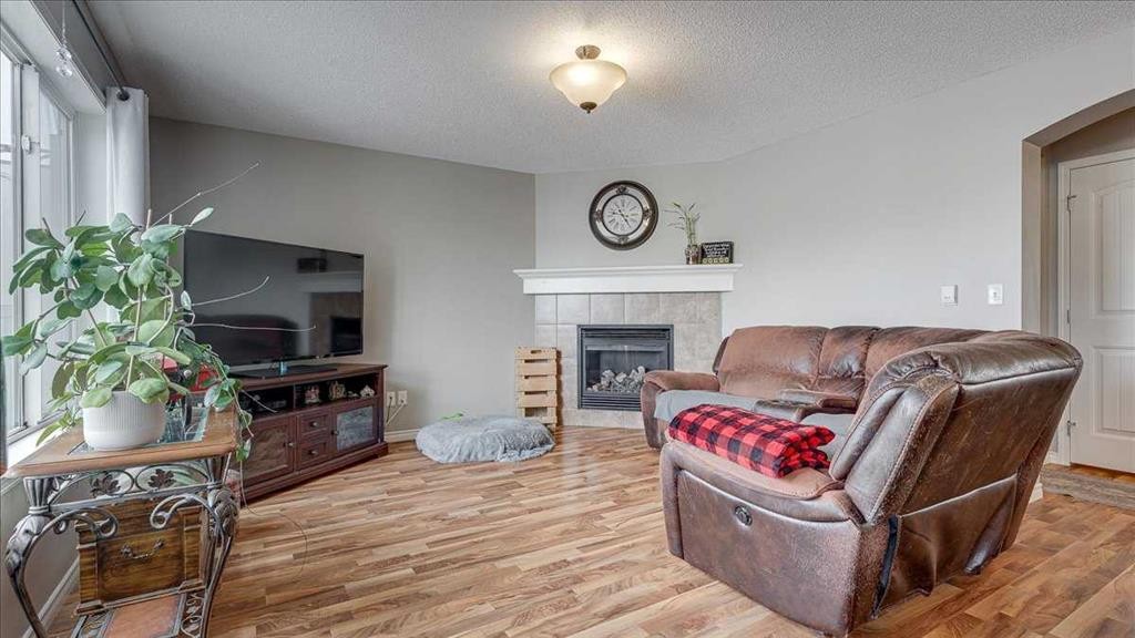 148 Valley Crescent, Blackfalds, AB - Indoor Photo Showing Living Room With Fireplace