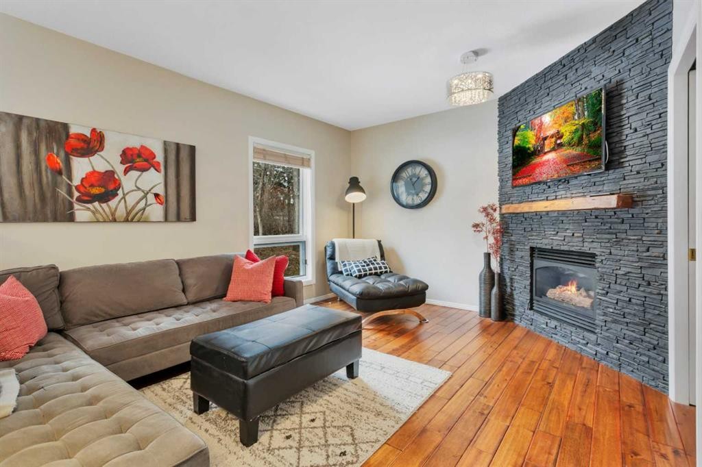 49 Coventry Lane, Lacombe, AB - Indoor Photo Showing Living Room With Fireplace