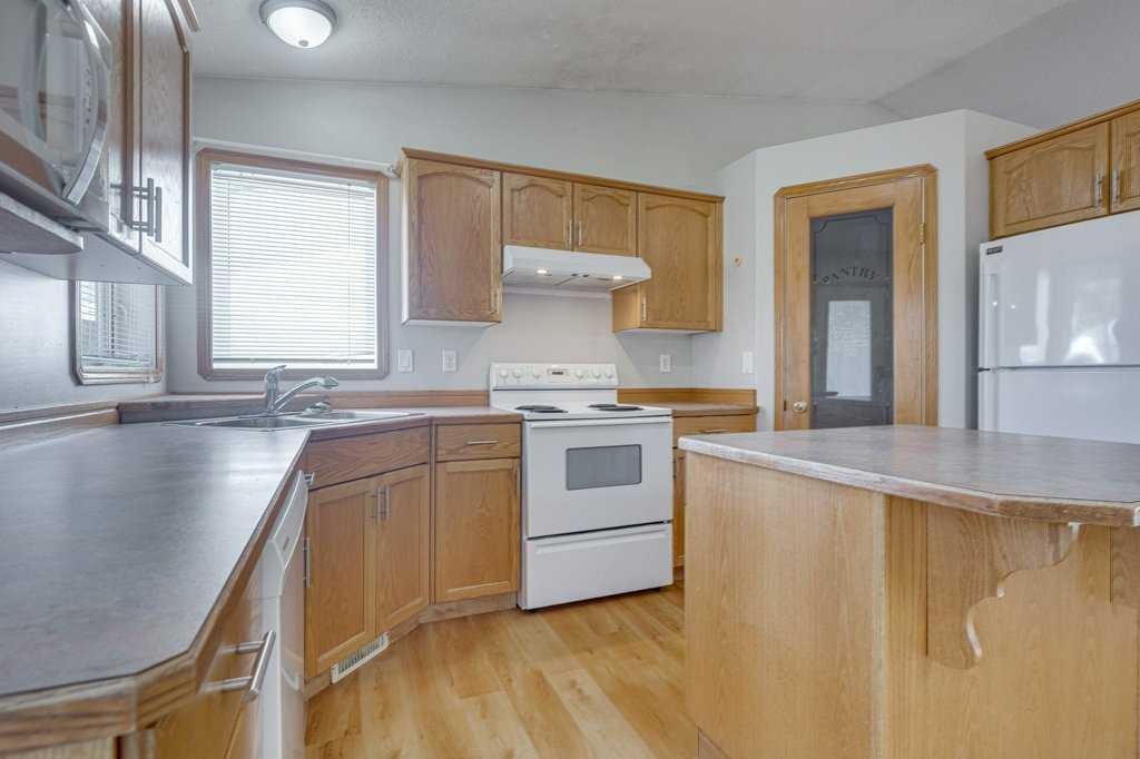 68 Herder Drive, Sylvan Lake, AB - Indoor Photo Showing Kitchen With Double Sink