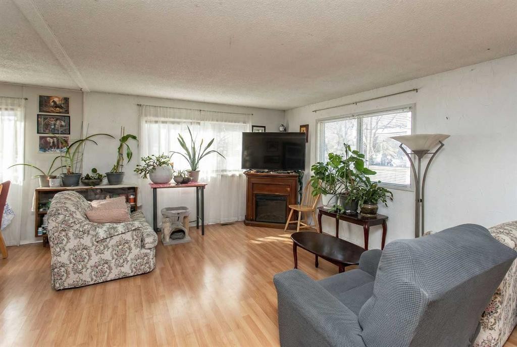 18 Hearthstone Drive, Lacombe, AB - Indoor Photo Showing Living Room With Fireplace