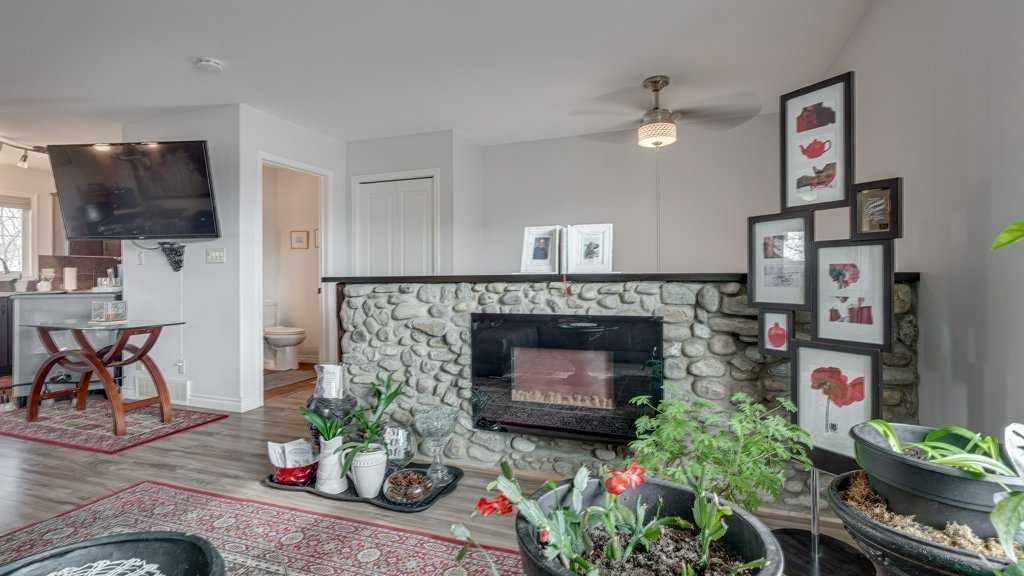 115 Redwood Boulevard, Springbrook, AB - Indoor Photo Showing Living Room With Fireplace