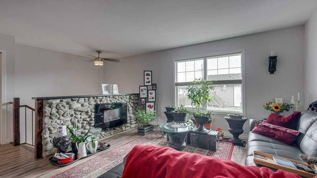 115 Redwood Boulevard, Springbrook, AB - Indoor Photo Showing Living Room With Fireplace