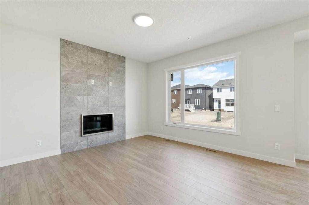 322 Hotchkiss Common Se, Calgary, AB - Indoor Photo Showing Living Room With Fireplace